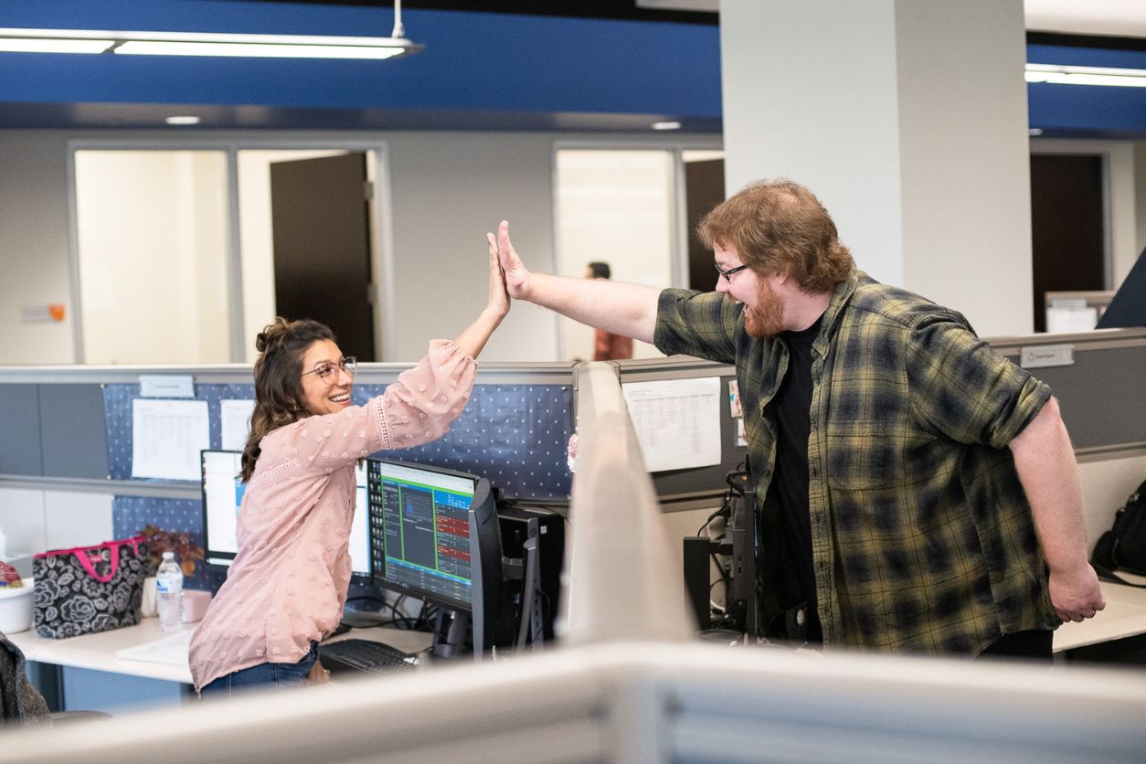 LCS Employees High-Fiving in Collaboration