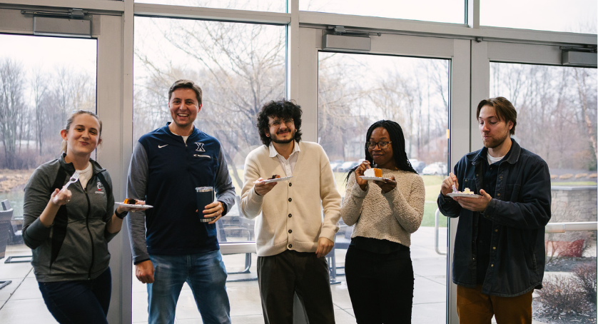 London Computer System employees at the office eating cake to celebrate Rent Manager's birthday. 