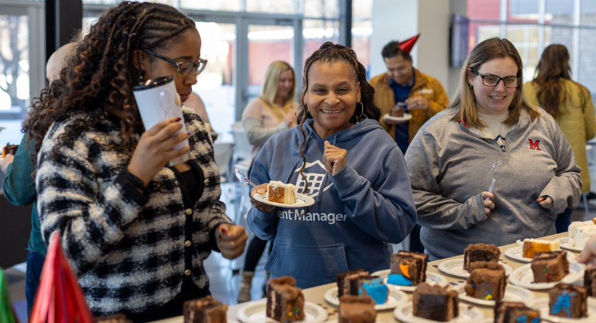 LCS employees celebrate LCS' Rent Manager's 37th birthday with cake.